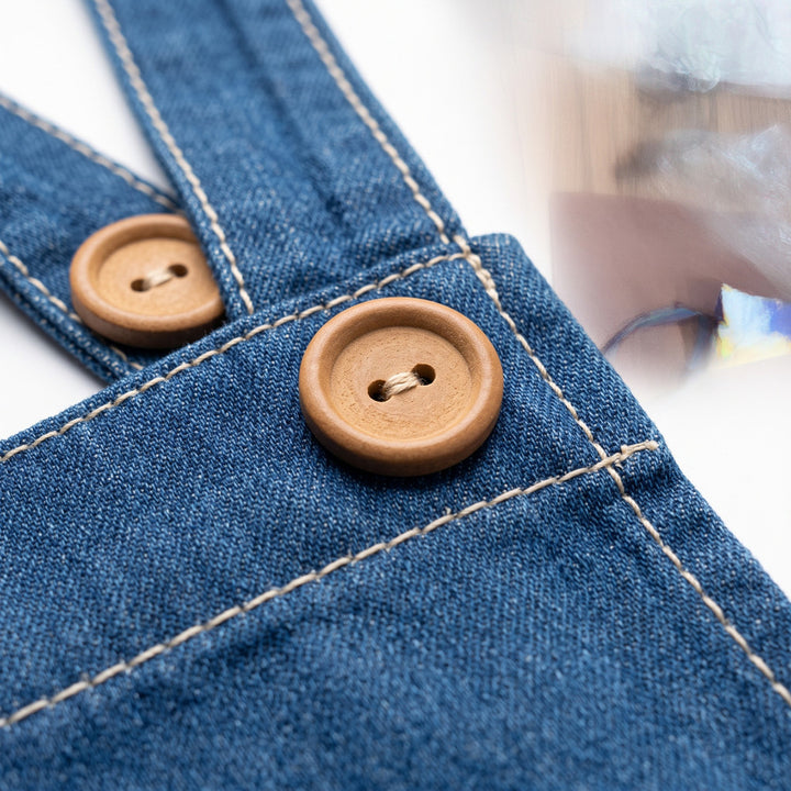 Wooden button detail on denim strap